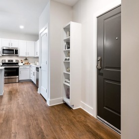 hallway in home showing easy accessibility to kitchen and rooms